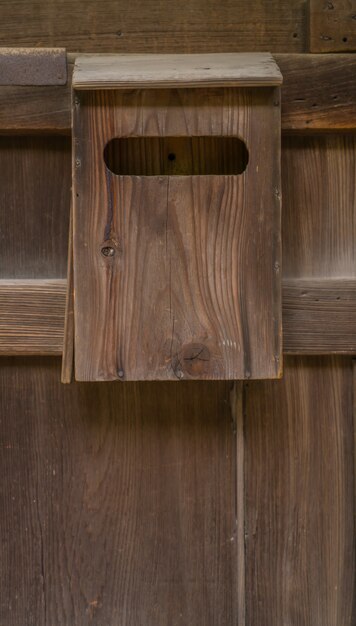 Old wooden mailbox on wood background .