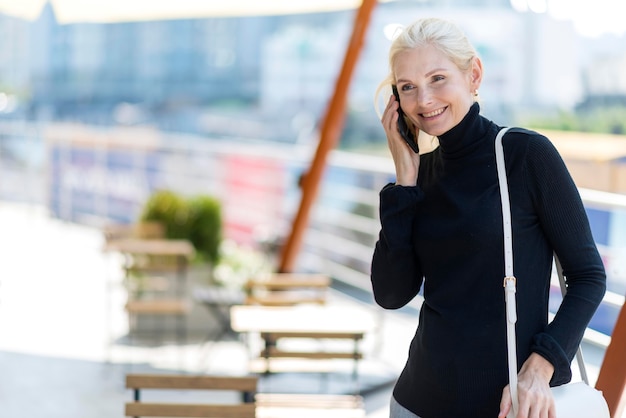 Older business woman outdoors on a phone call