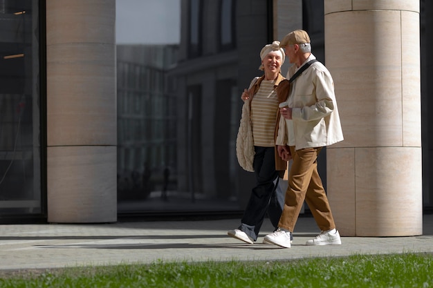 Older couple outdoors in the city with a cup of coffee