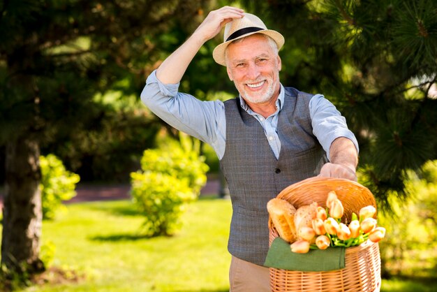 Older man with a basket outdoors
