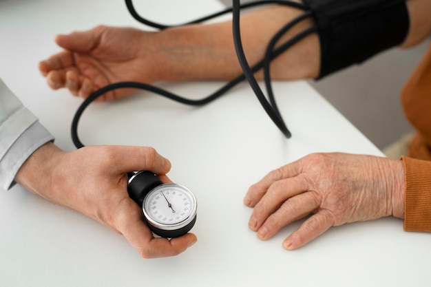 older person checking their blood pressure with tensiometer