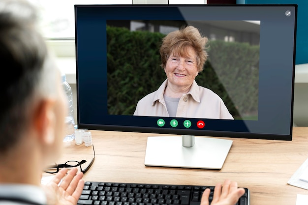 Free photo older person using the video call feature on their device