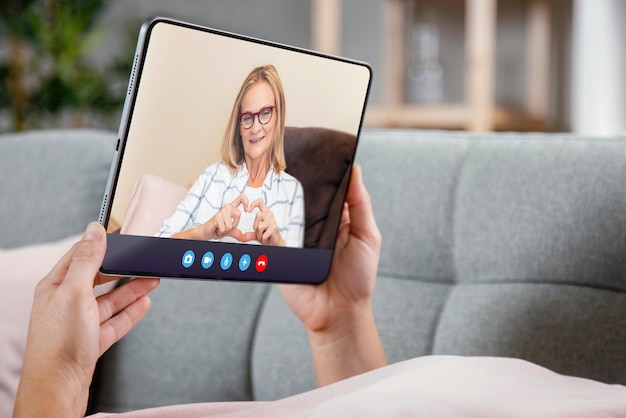 Free photo older person using the video call feature on their device