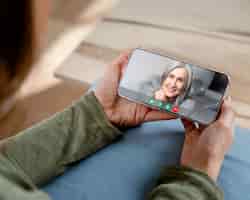 Free photo older person using the video call feature on their device