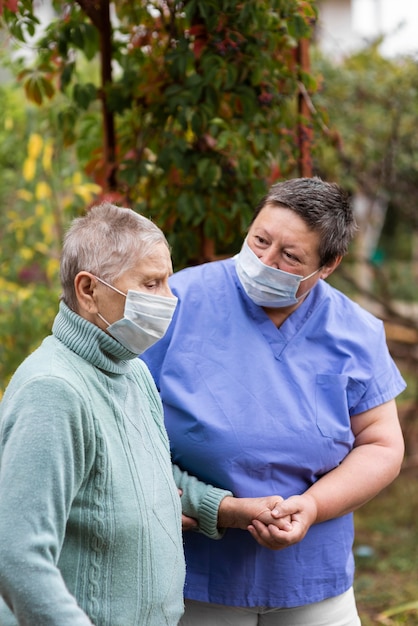 Older woman being taken care by female nurse