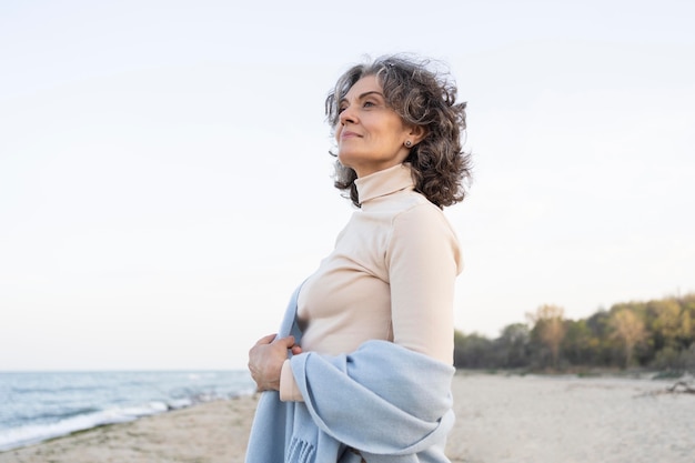 Older woman enjoying her time at the beach