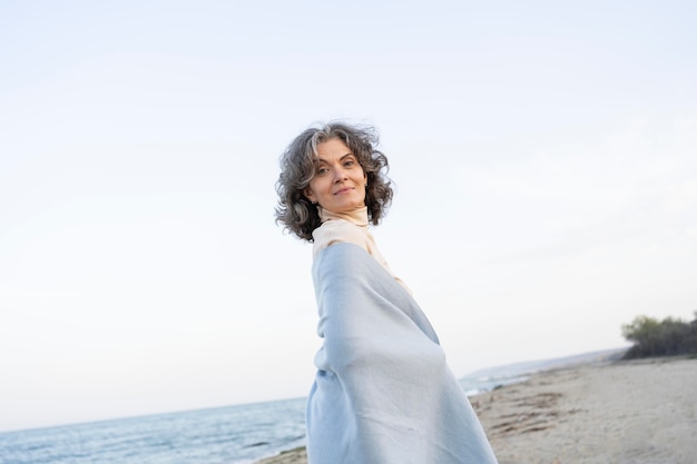 Older woman enjoying her time at the beach