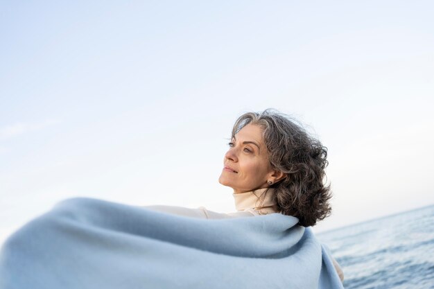 Older woman enjoying her time at the beach