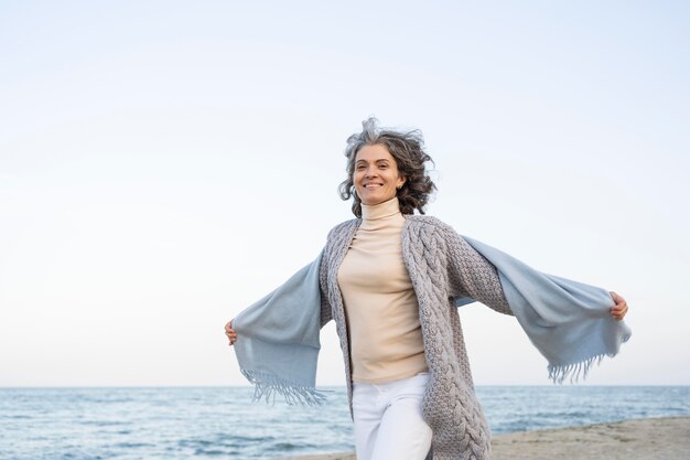 Older woman enjoying her time at the beach