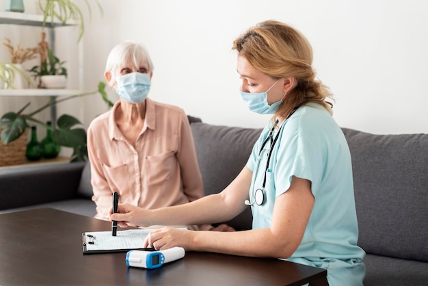 Older woman getting her check-up with nurse