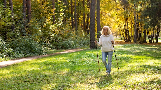 Older woman in nature trekking