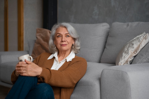 Free photo older woman reading while using a magnifying glass