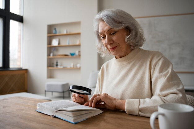 Older woman using a magnifying glass to read