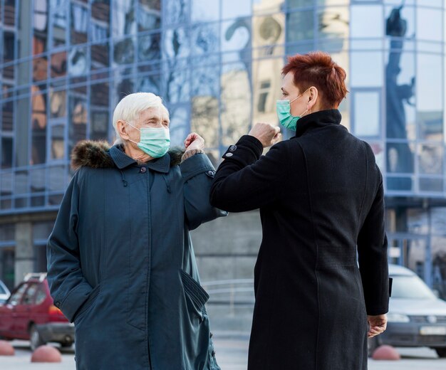 Older women greeting each other while in the city