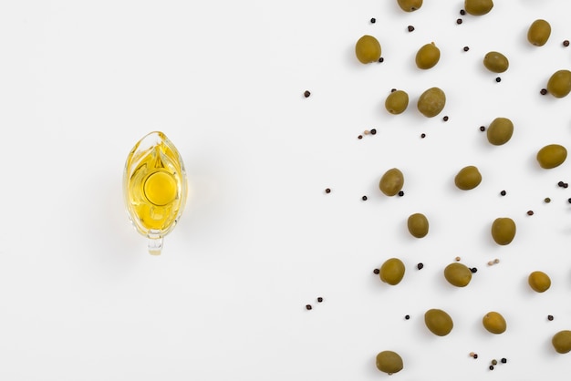 Olive on cup with olives around on table