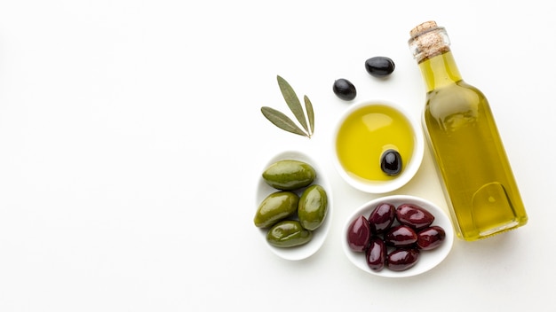 Download Premium Photo High Angle Olive Oil Bottle And Saucer With Yellow Olives And Copy Space PSD Mockup Templates
