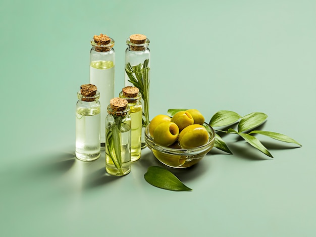 Olive oil and olive branch on the wooden table