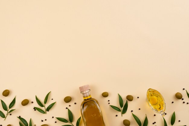 Olive oil on pink background with copy space