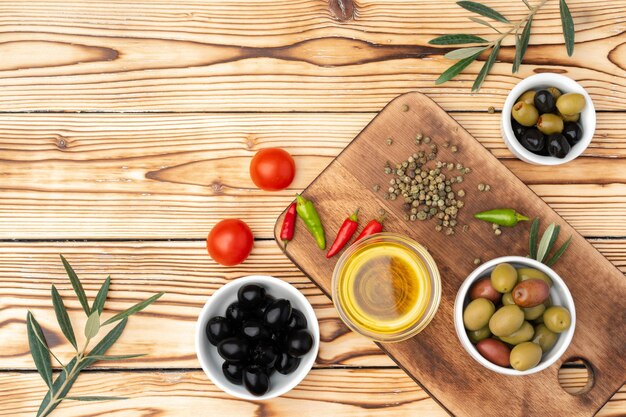 Olive oil and spices on wooden background