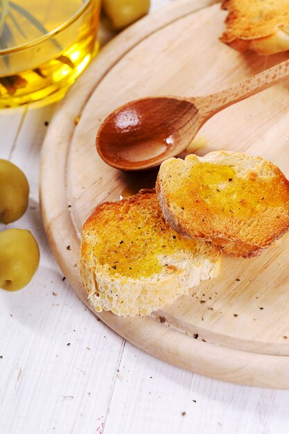 Olive oil with bread and spoon