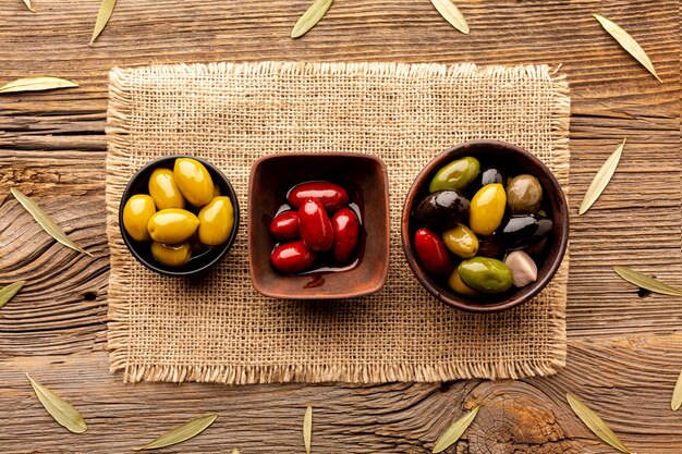 Olives in bowls on textile material