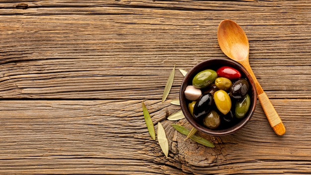 Olives mix and wooden spoon with copy space
