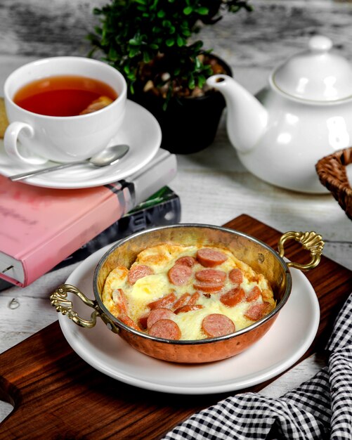 Omelette with sausage and black tea