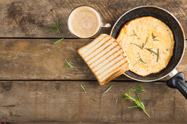 Omelette with toast near coffee