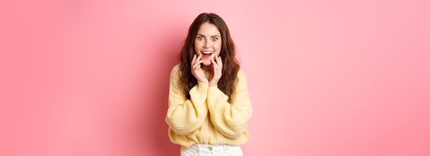 Free photo omg really excited young woman hear gossip or super good news staring amazed smiling and holding han