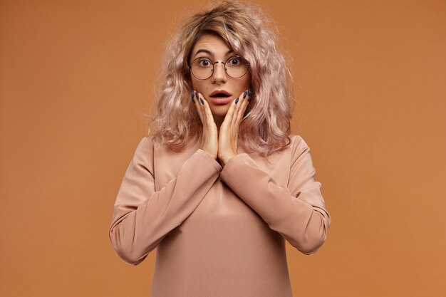 Free Photo | Omg. shot of emotional funny student girl with nose ring expressing shock. surprised shocked young woman wearing round glasses opening mouth widely Free Photo | Omg. shot of emotional funny student girl with nose ring expressing shock. surprised shocked young woman wearing round glasses opening mouth widely