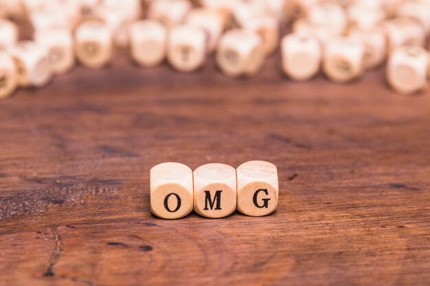 Omg written on a wooden cubes