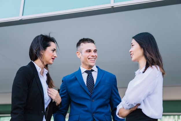 Free photo one businessman and two businesswomen laughing