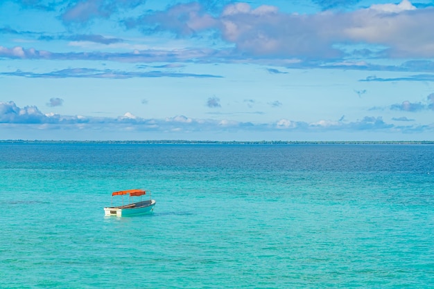 One fishing boat in water of Indian ocean. Zanzibar, Tanzania