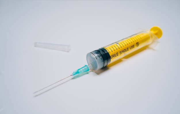 One one-off yellow medical syringe with needle lying