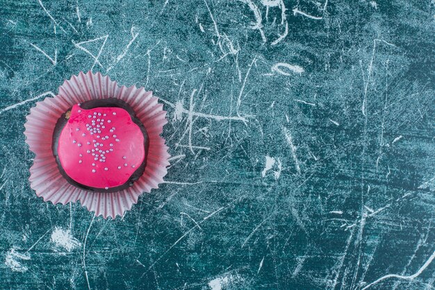 A one whole fresh sweet doughnut with pink frosting. High quality photo