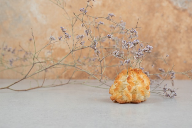 Free photo one whole sweet cupcake with withered flower