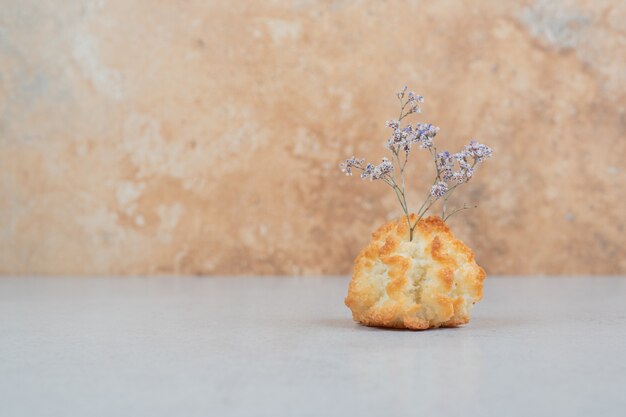 Free photo one whole sweet cupcake with withered flower