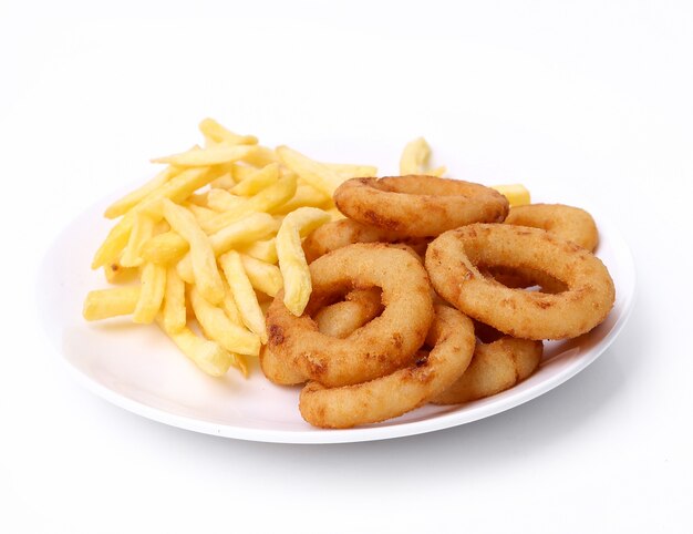 Onion rings and fries on white