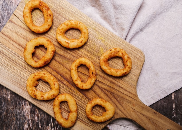 Onion rings on wooden table