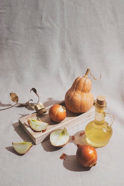 Onions and pumpkin on wooden board