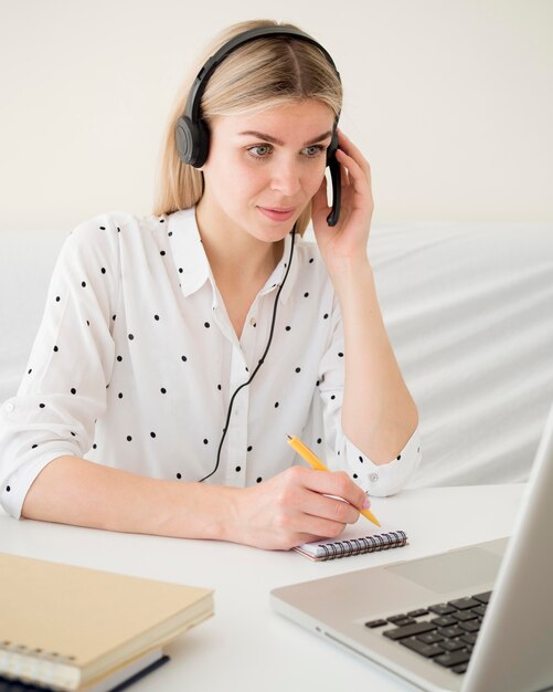 online classes with student holding her headphones