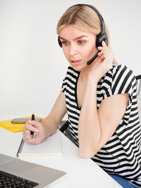 Online remote courses student listening on headphones