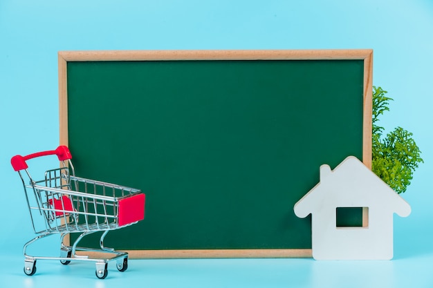 Online shopping , a double cart placed on a green board on a blue  .