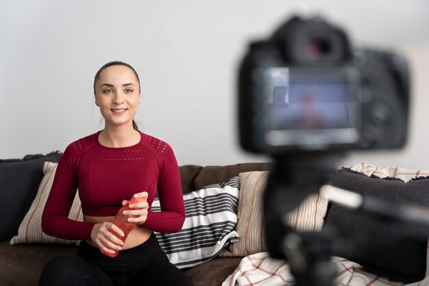 Online sport fitness instructor recording her session