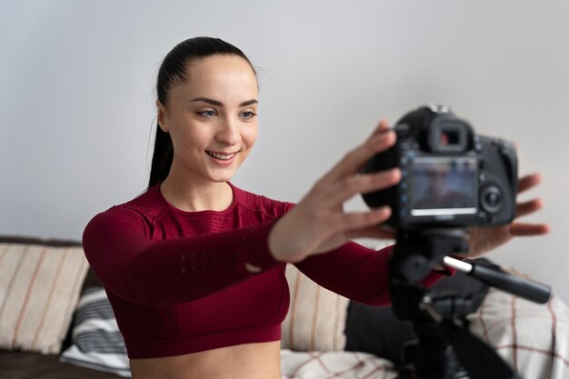 Online sport fitness instructor recording her session