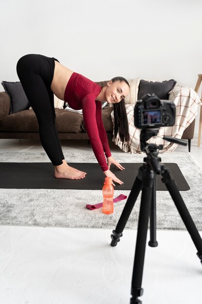 Online sport fitness instructor recording her session