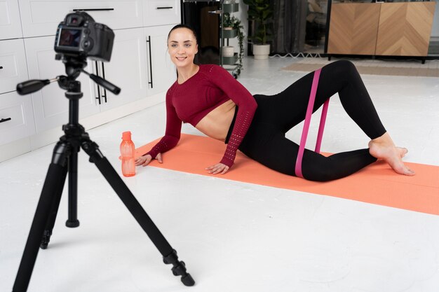 Online sport fitness instructor recording her session