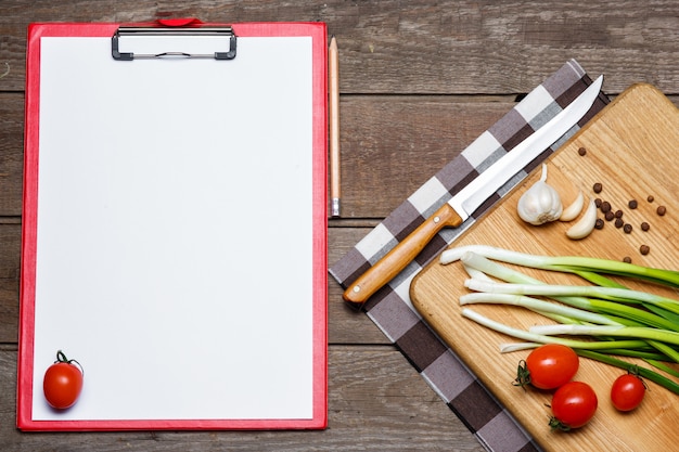 Open blank recipe book on brown wooden 