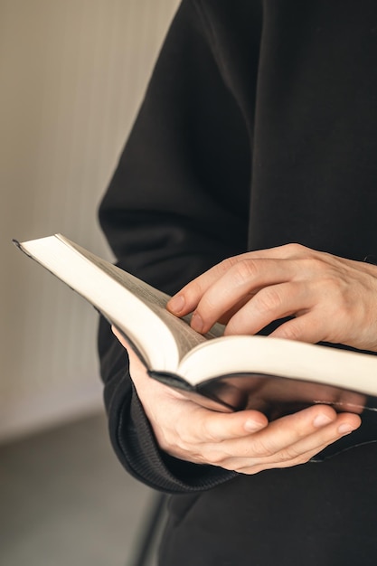 Open book Bible in male hands closeup