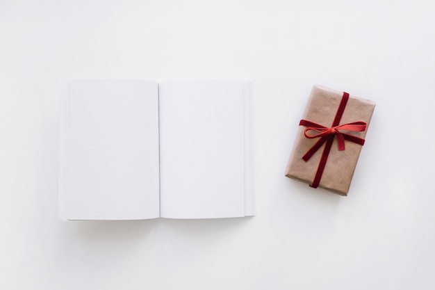 Open book mockup with gift box